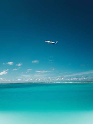 gan international airport photo of airplane over body of water addu city